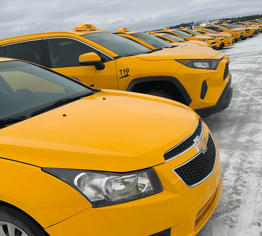 Row of parked yellow taxi cabs.